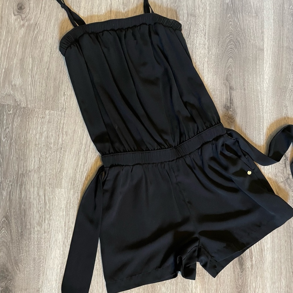 Black short romper.  Guess size small.